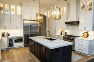 Luxury custom kitchen with stainless steel gas stove, white cabinets and gold fixtures plus quartz white countertops - remodel done by CMK construction