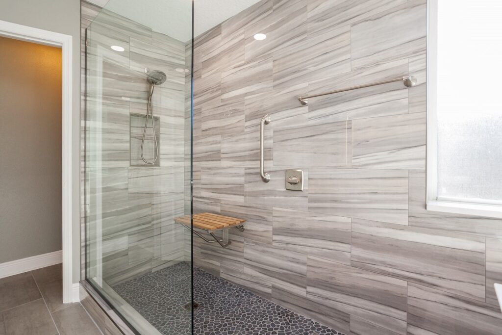 Modern bathroom featuring a new walk-in shower replacing an old bathtub