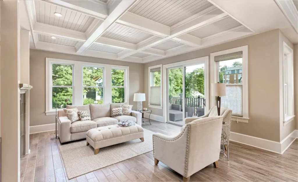 Bright living room with large windows and cozy furniture. Home Room addition by Tampa top home remodelers for 20 years: CMK Construction