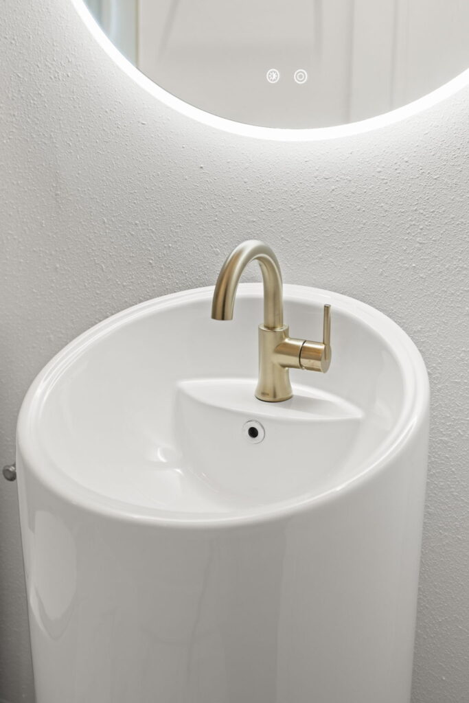 Modern bathroom sink with brass faucet in St. Petersburg, FL