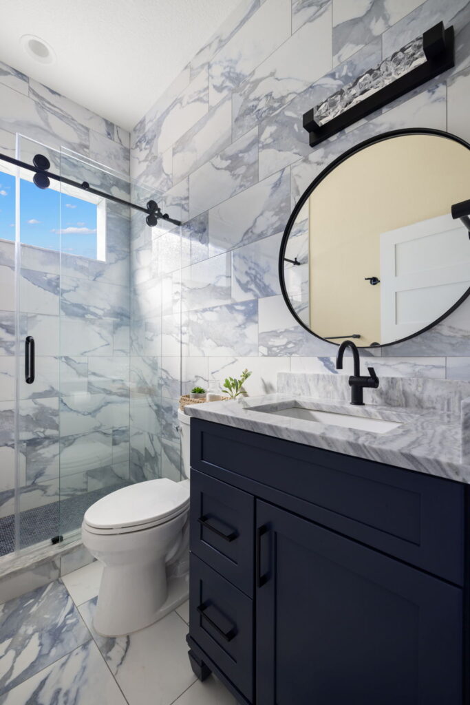 Modern bathroom with marble and navy vanity