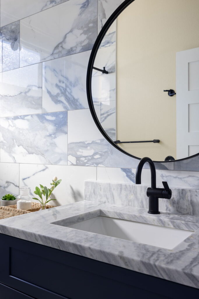 Elegant bathroom with marble sink and round mirror