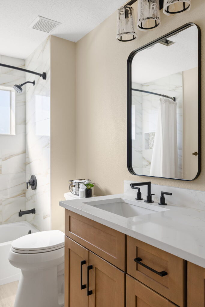 Modern bathroom with wooden vanity and marble shower