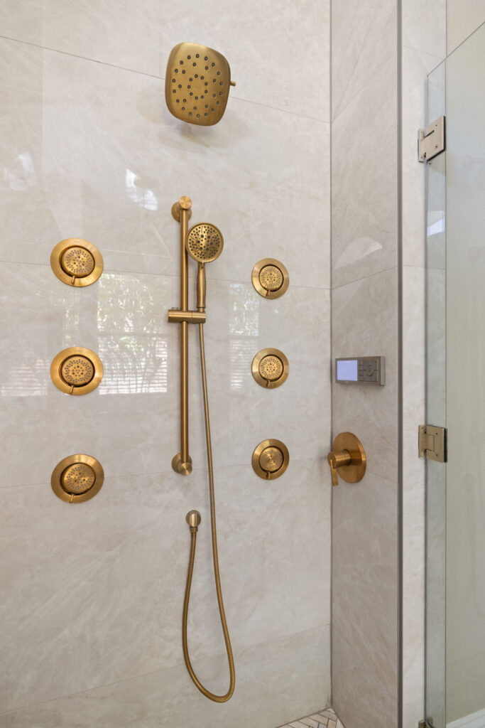Luxury gold shower with multiple jets and controls.