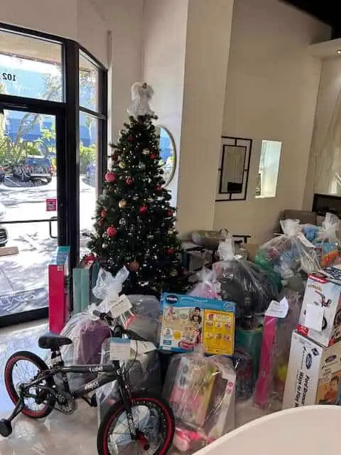 Christmas tree with gifts in a lobby.
