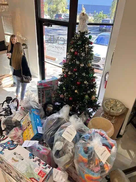 Christmas tree surrounded by gifts in a room.