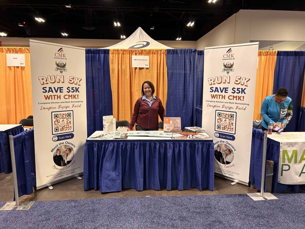 CMK Construction booth promoting 5K run at event.