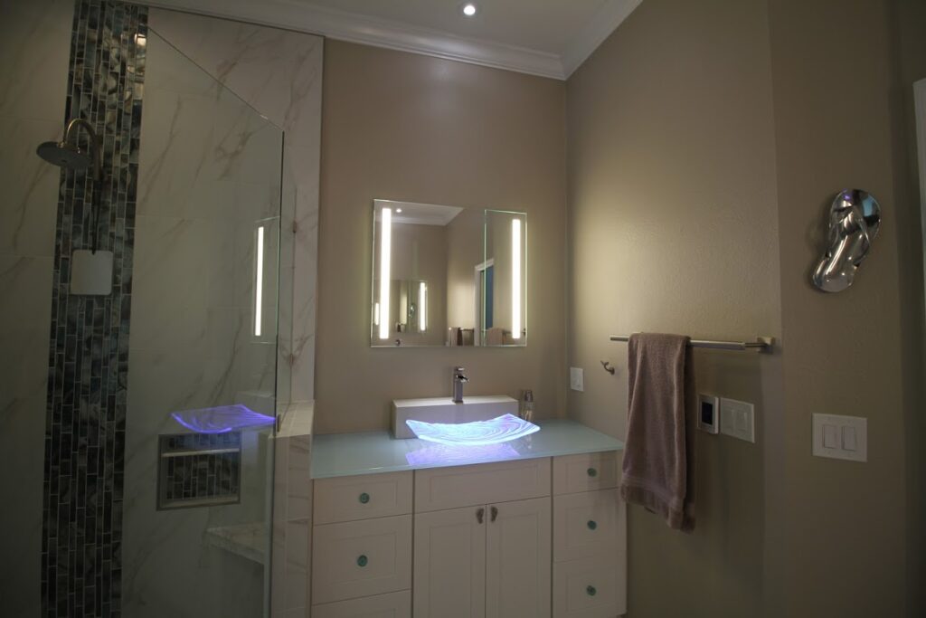 Custom vanity with lighting in a remodeled bathroom