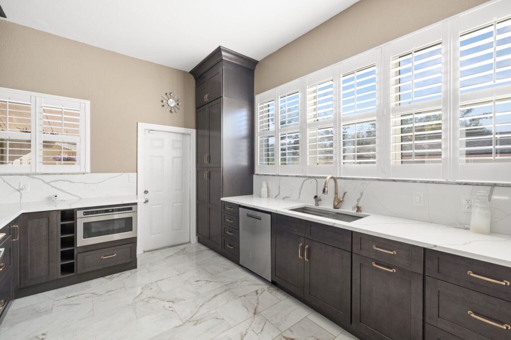 White countertop kitchen with dark cabinets