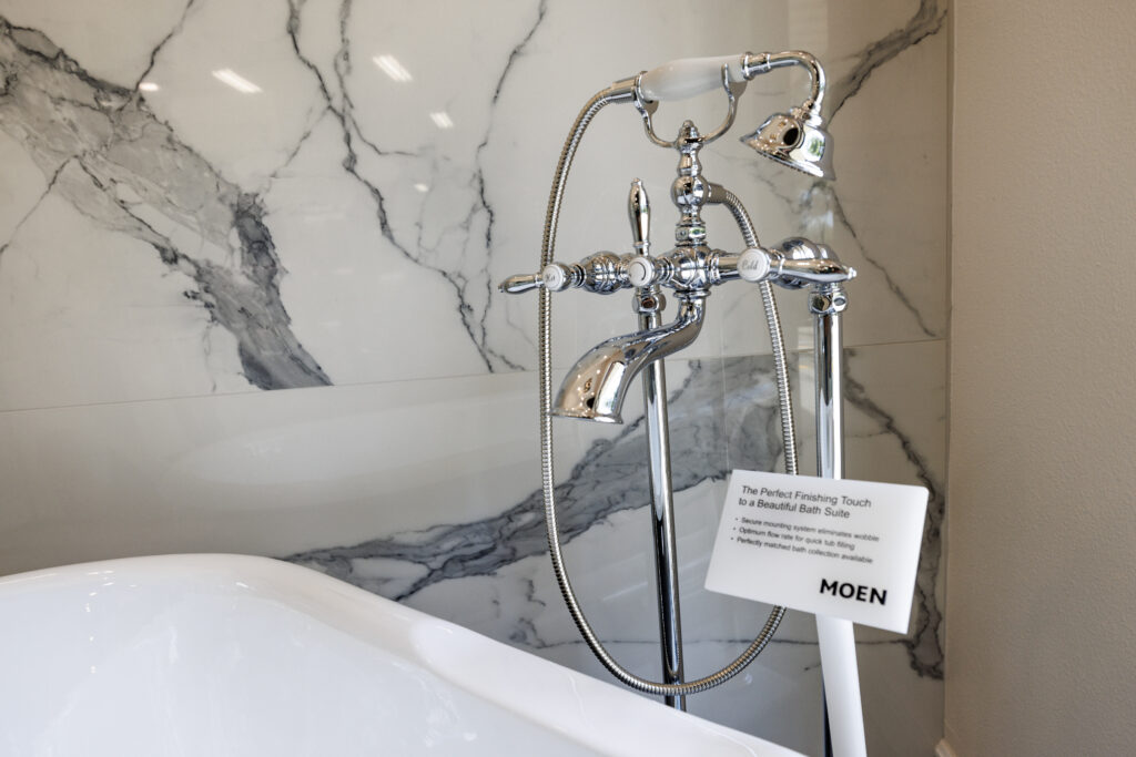 Elegant bath faucet showcasing marble wall background.