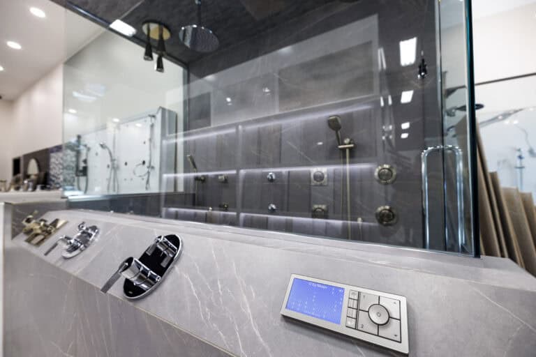 Close-up of a control panel for a modern shower, including a digital temperature control panel.