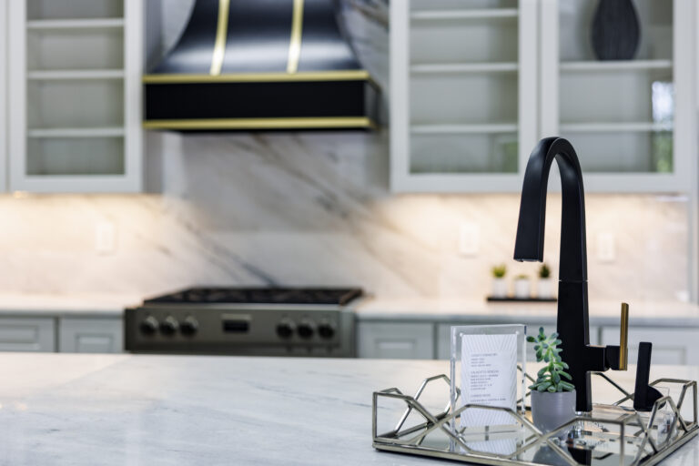 Modern kitchen with sleek sink and decor.