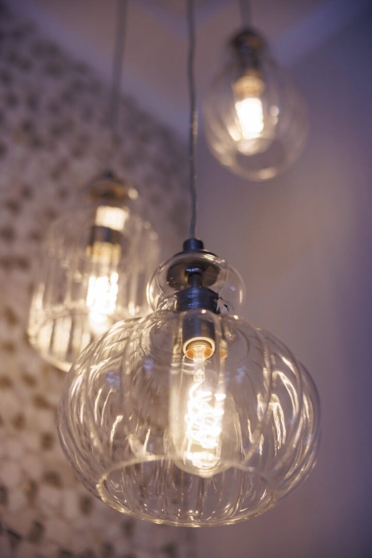 A trio of lightbulbs suspended in a modern design.