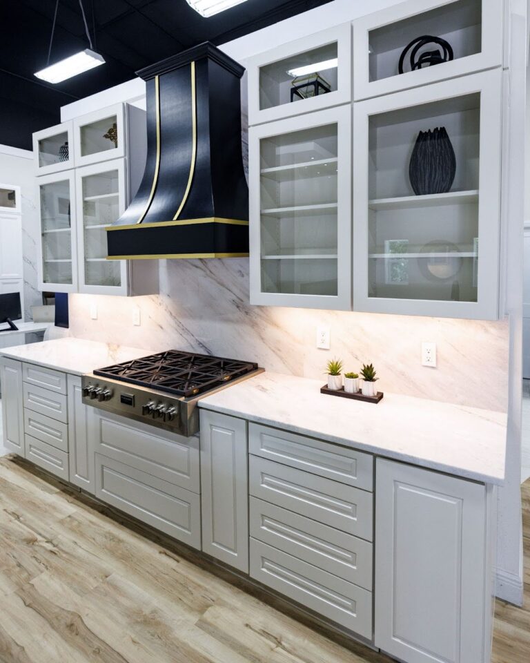 Modern kitchen with elegant cabinetry and marble countertops.