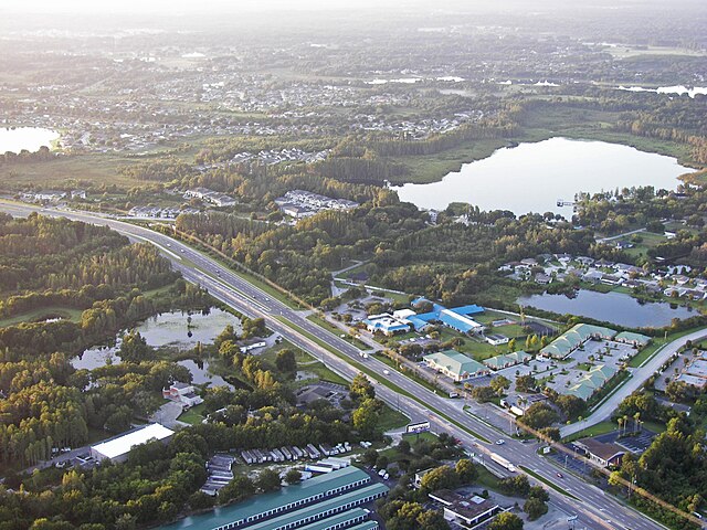 Aerial view of a landscape with water and roads.