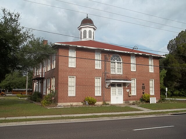 Historic brick building with a steeple.