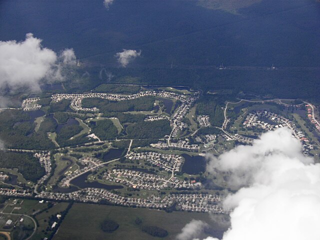 Aerial view of suburban development and greenery.
