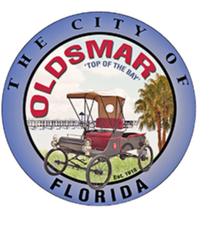 City seal of Oldsmar, Florida featuring vintage car.