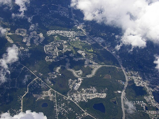 Aerial view of a suburban landscape and clouds.
