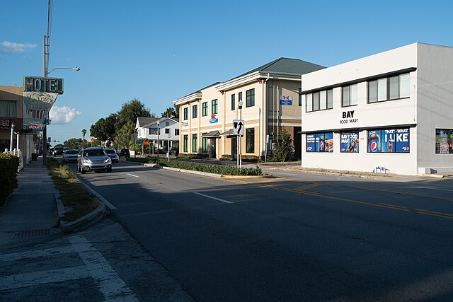 Street view with businesses and vehicles.