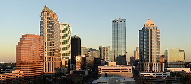 City skyline at sunset with modern skyscrapers.