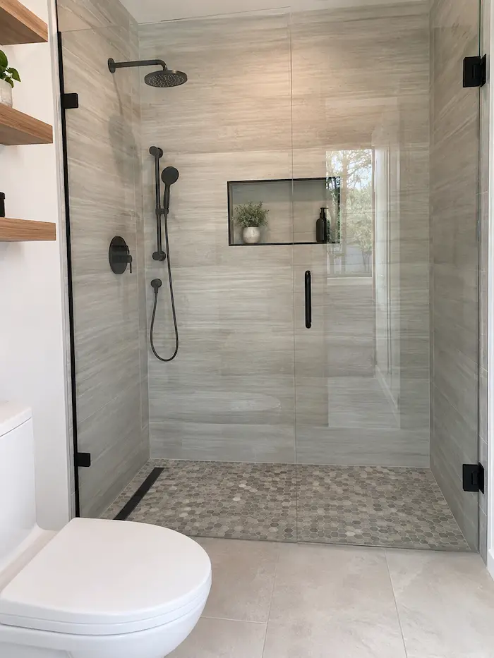Minimalist bathroom remodel with a walk-in shower and matte black fixtures in Tampa, FL