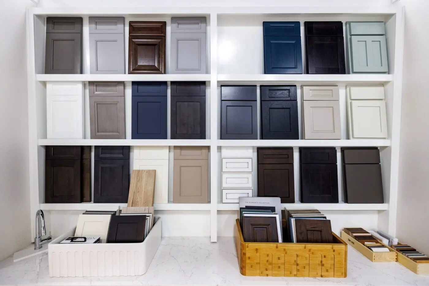 A wall of kitchen cabinet door styles and finishes on display at the CMK Design Studio in Tampa