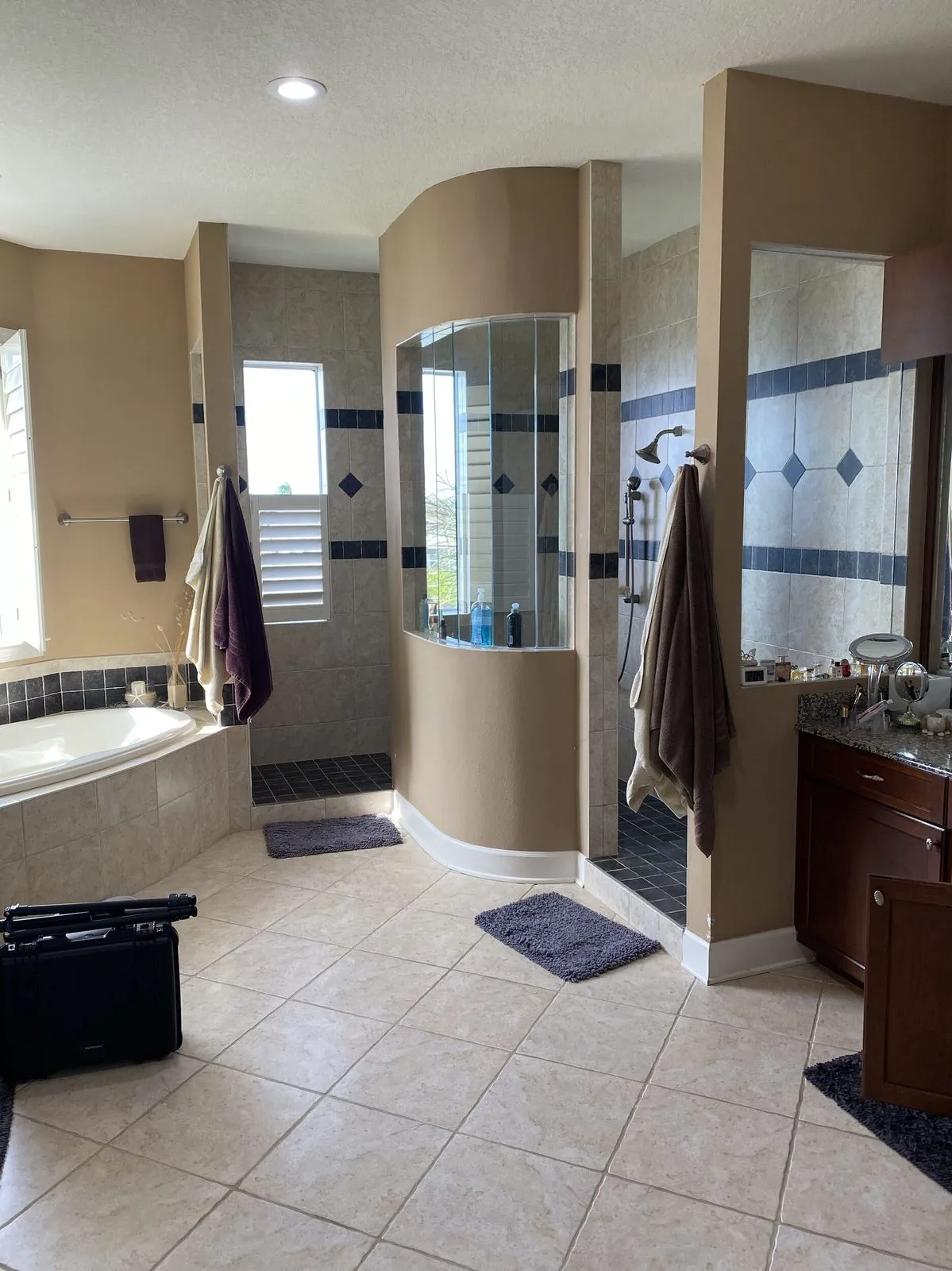 Primary bathroom before remodeling in a Lansbrook waterfront home in Palm Harbor with corner garden tub and curved walled shower