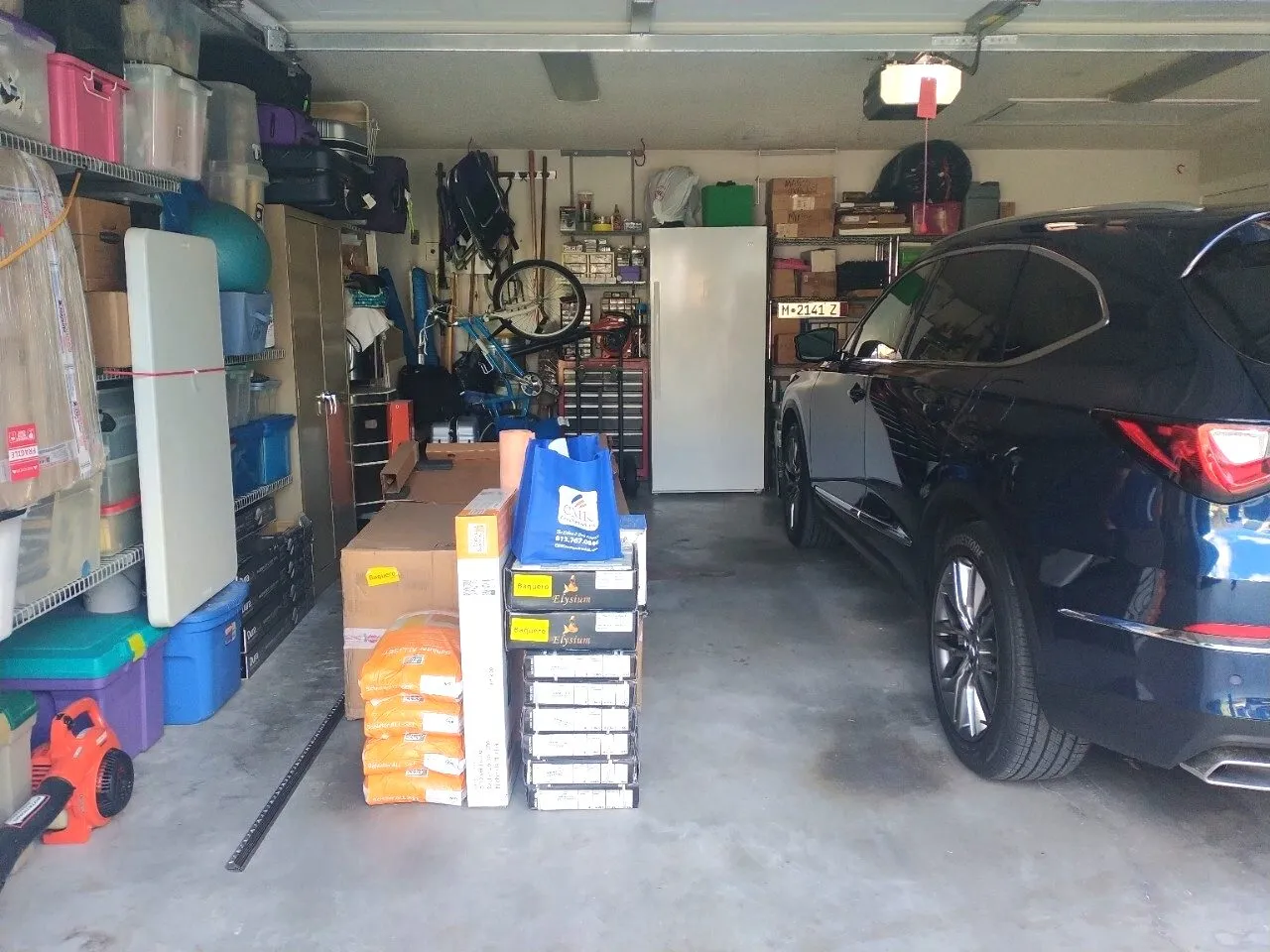 Bathroom remodel materials including tile and Schluter waterproofing staged in a Safety Harbor garage before demolition