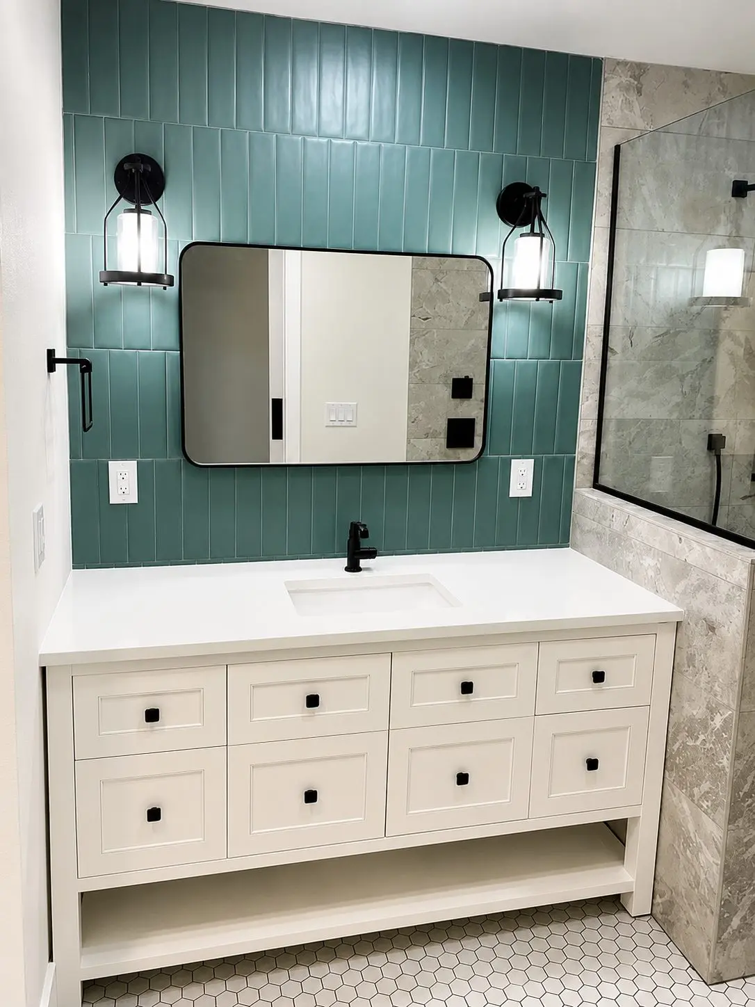 Bathroom with deep green vertically stacked tile vanity wall, white hexagon floor tile, and stone look shower in a Treasure Island remodel