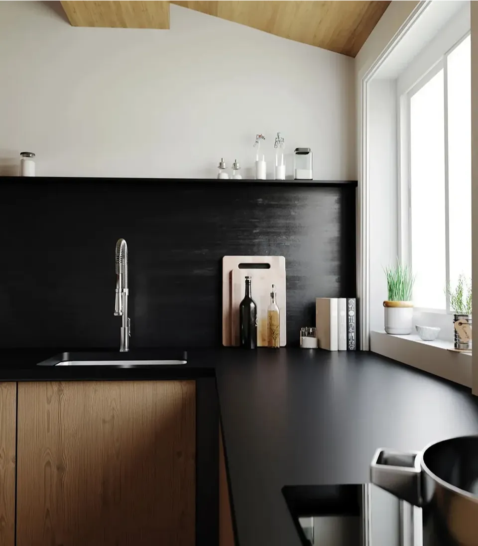 Cambria Blackpool Matte black quartz countertop and full-height backsplash with wood cabinetry