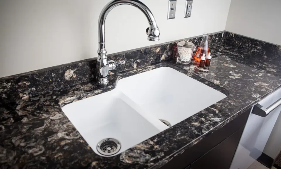 Dark speckled Cambria quartz countertop with a white undermount sink in a St. Petersburg kitchen