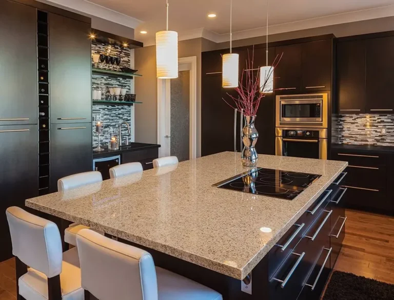 Contemporary kitchen featuring a large wooden island with bar stools and pendant lighting.