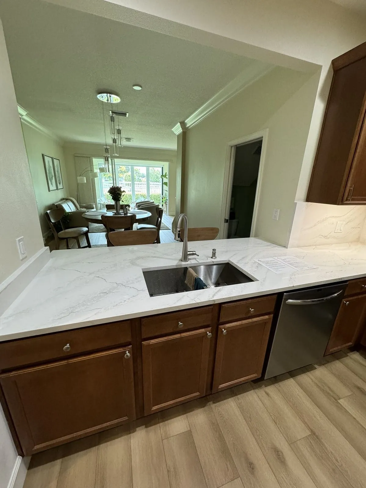 Cambria quartz kitchen peninsula with pass-through opening to the dining room in a Pinellas Park FL condo remodel