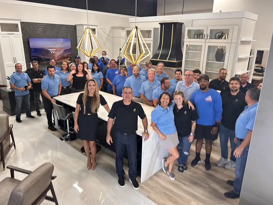 The CMK Construction team, including designers, project managers, office staff, and field crews, gathered in the Design Studio kitchen in Tampa