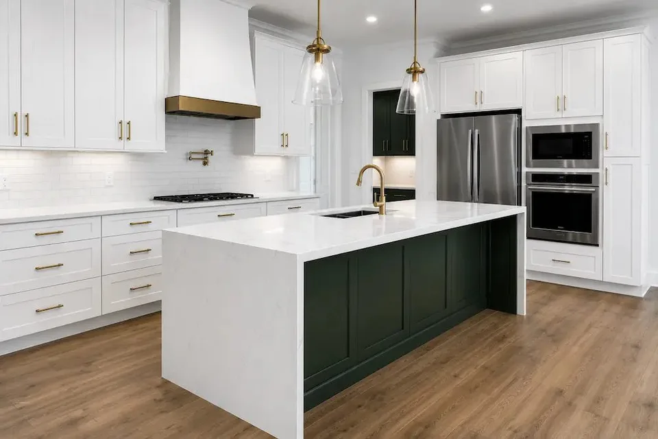 dark green kitchen island with white quartz waterfall countertop in a Largo remodel by CMK Construction