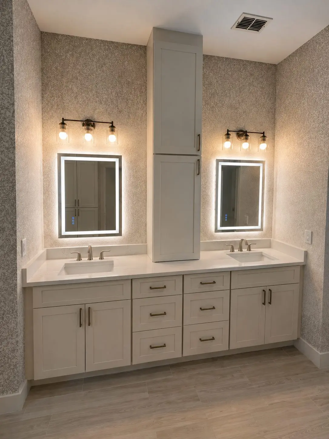 Cream double vanity with center storage tower and LED backlit mirrors in a Wesley Chapel bathroom remodel