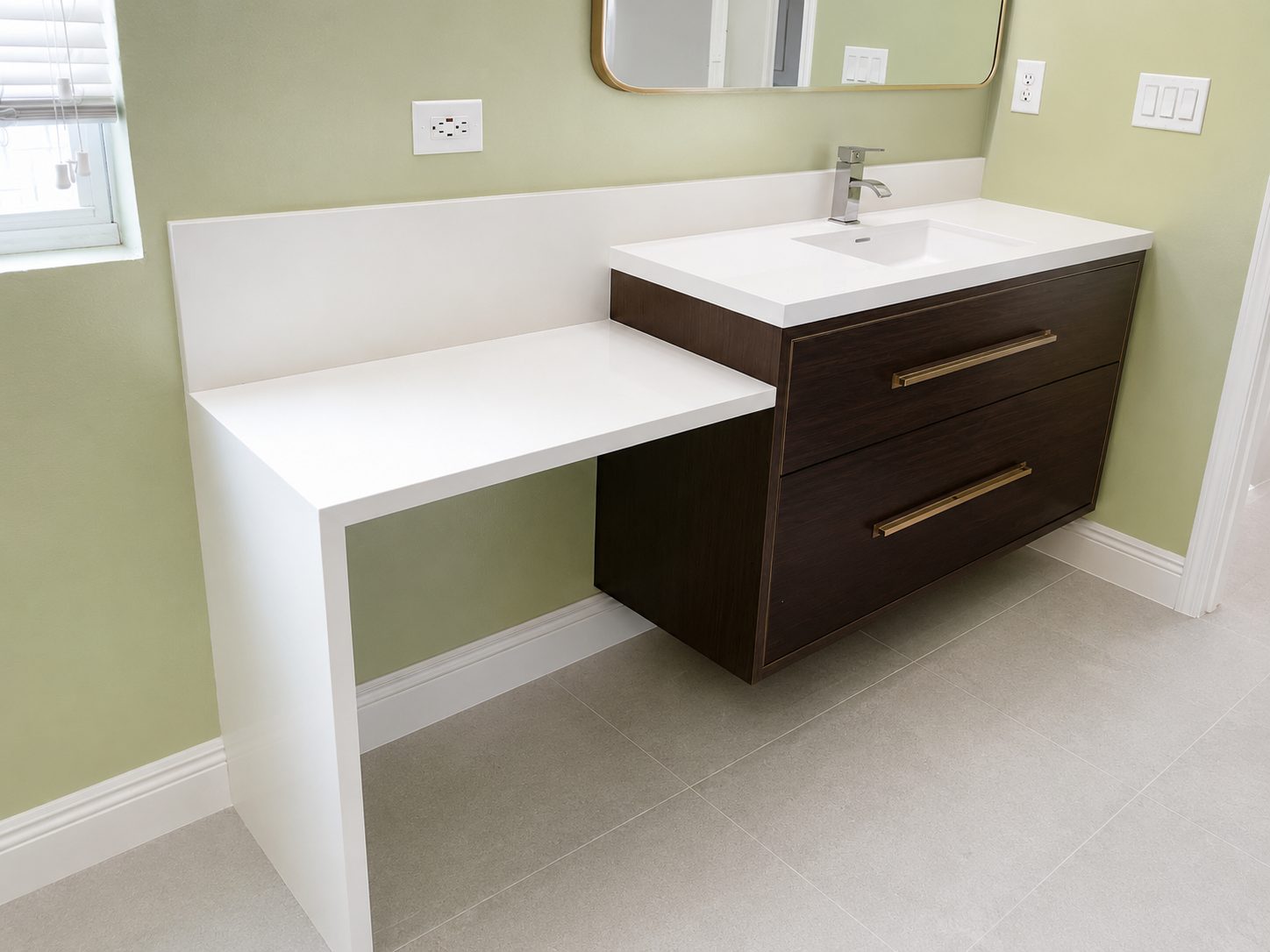 Floating walnut vanity with attached seated makeup counter and white countertop in a Tampa bathroom remodel