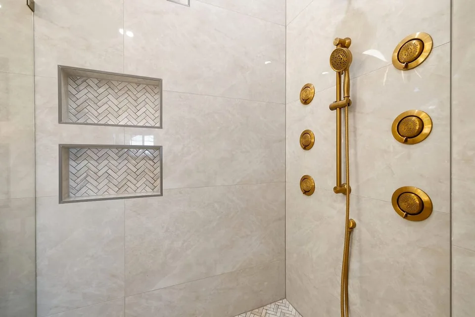 Large format tile shower walls with stacked herringbone niches in Trinity FL