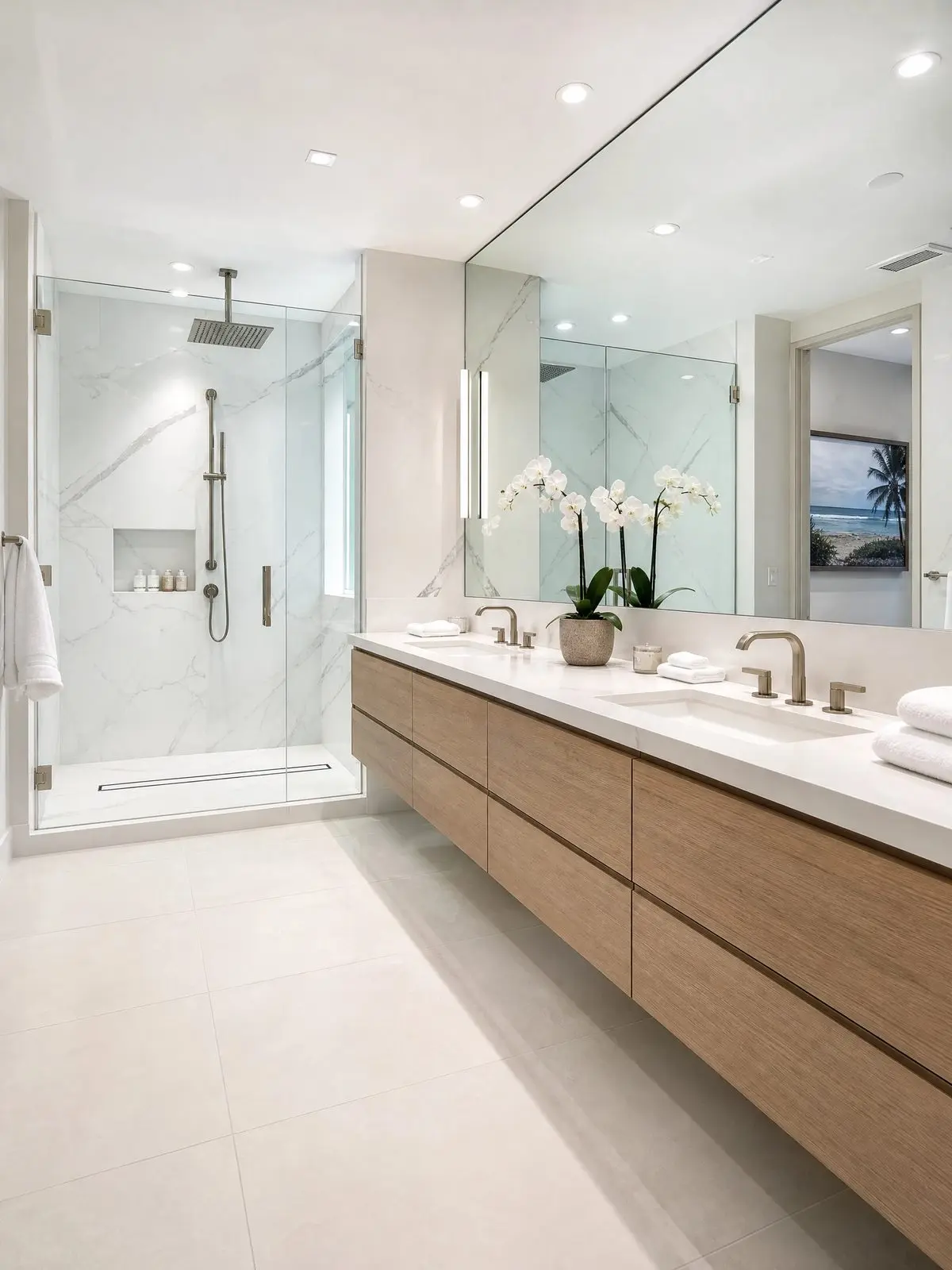 Primary bathroom remodel on Longboat Key with a walk in shower, marble look porcelain, and a floating white oak double vanity