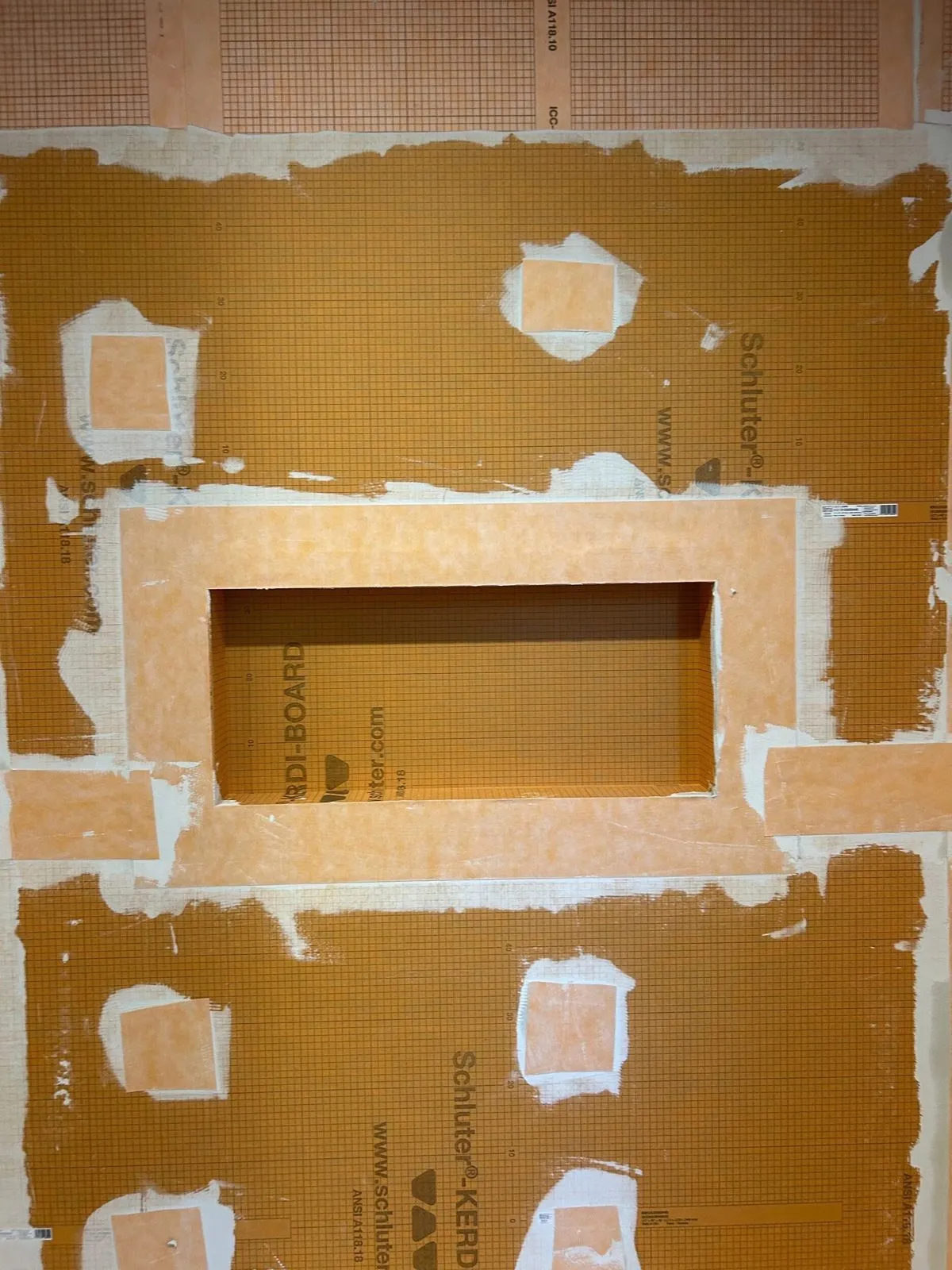 Schluter KERDI-BOARD waterproofed shower niche before tile installation in a Wesley Chapel bathroom remodel by CMK