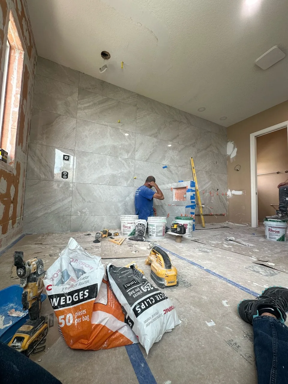Large format porcelain wall tile installed over Schluter Kerdi membrane with a waterproofed shower niche in a Tampa master bathroom remodel