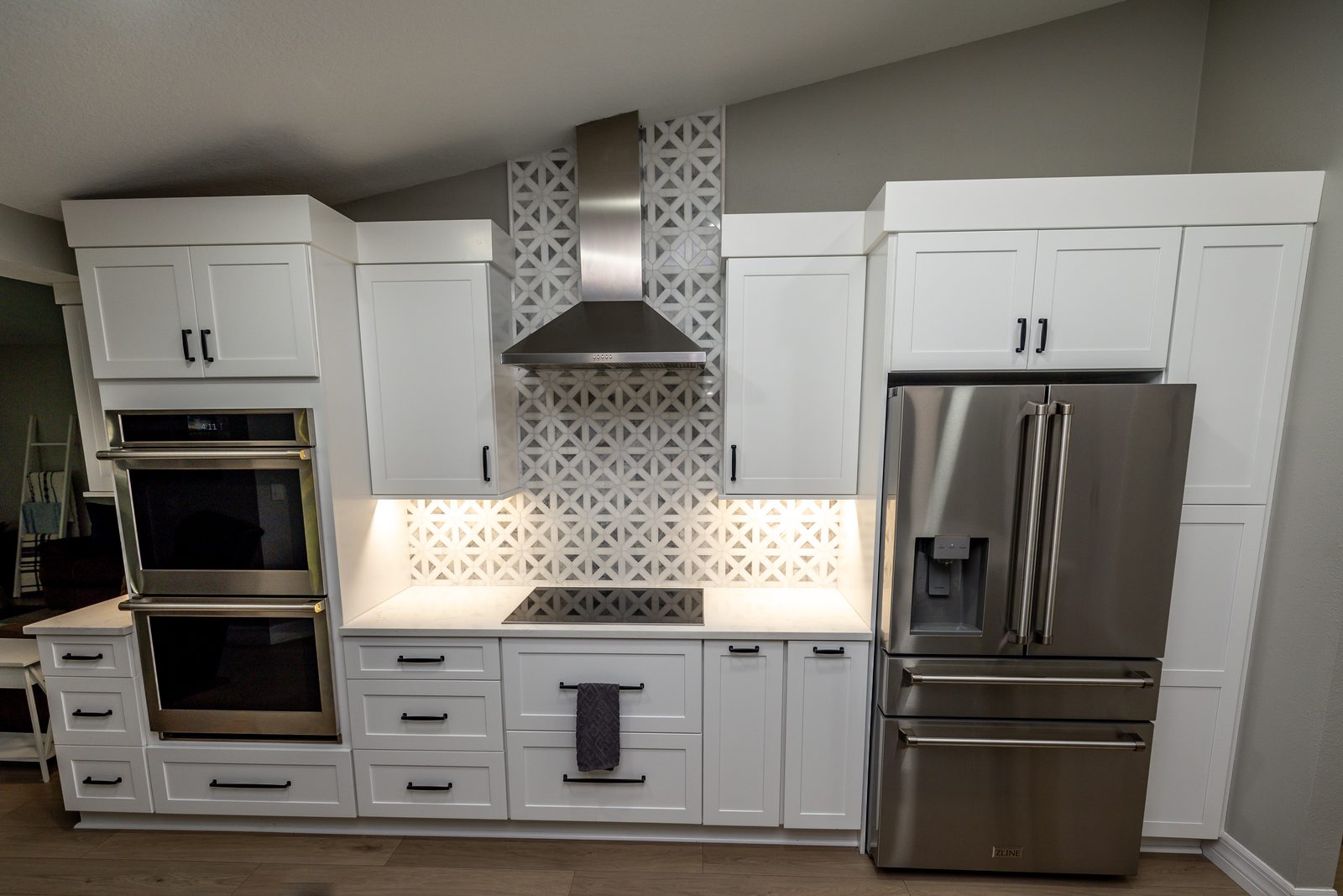 white kitchen with matte black hardware in tampa florida, fabuwood allure galaxy frost cabinets and geometric mosaic backsplash by cmk construction