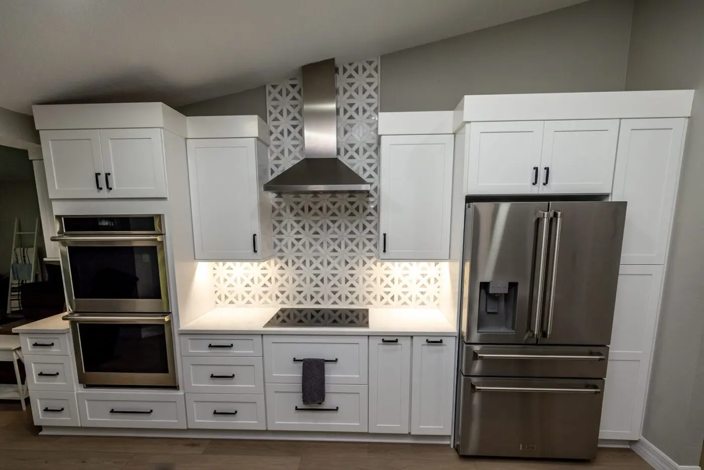 white kitchen with matte black hardware in tampa florida, fabuwood allure galaxy frost cabinets and geometric mosaic backsplash by cmk construction