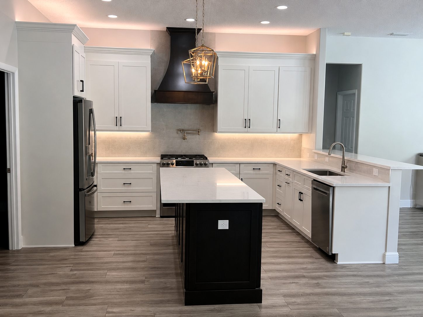 white kitchen with espresso island and black statement hood in st petersburg florida by cmk construction